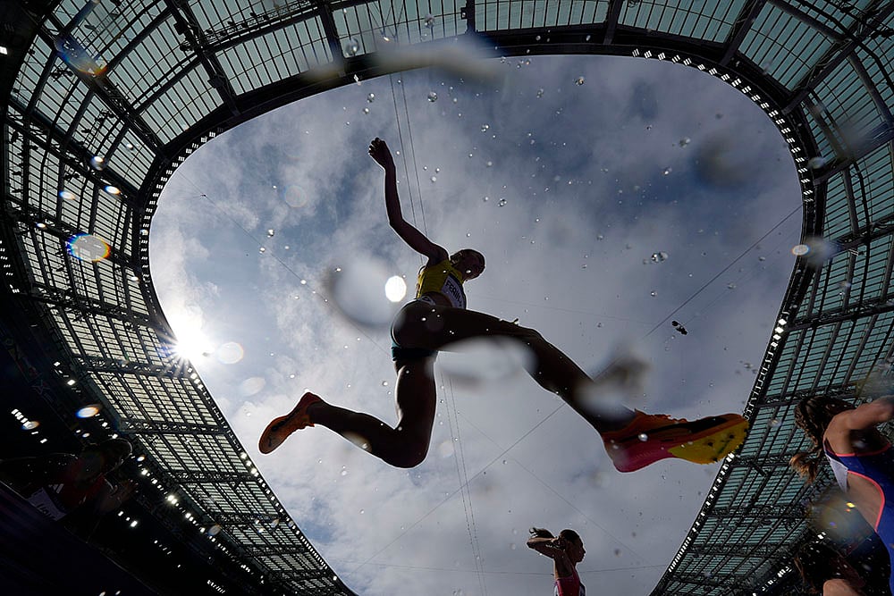 | Photo: AP/Matthias Schrader : Cara Feain-Ryan competes competes in women's 3000-meter steeplechase